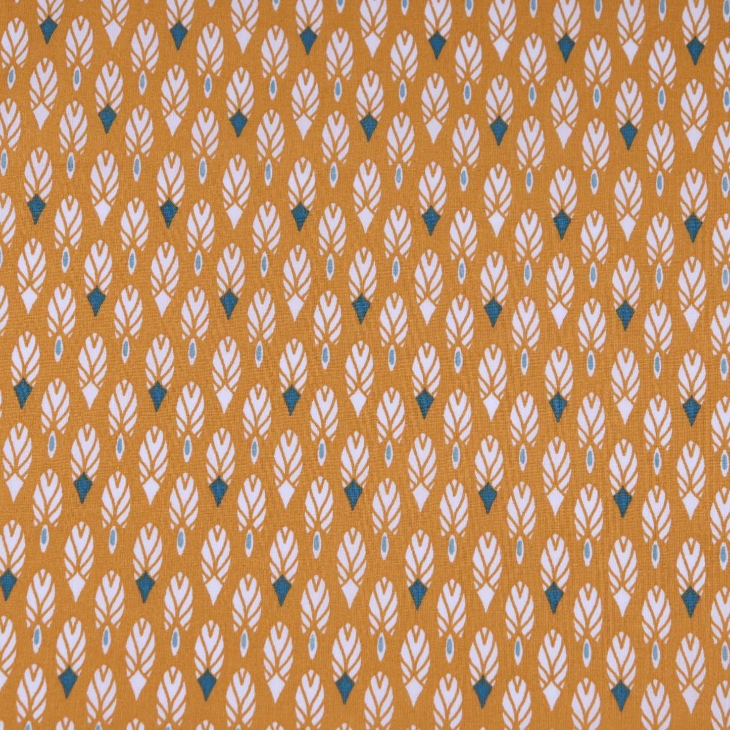 Printed ochre cotton fabric with white and navy feathers