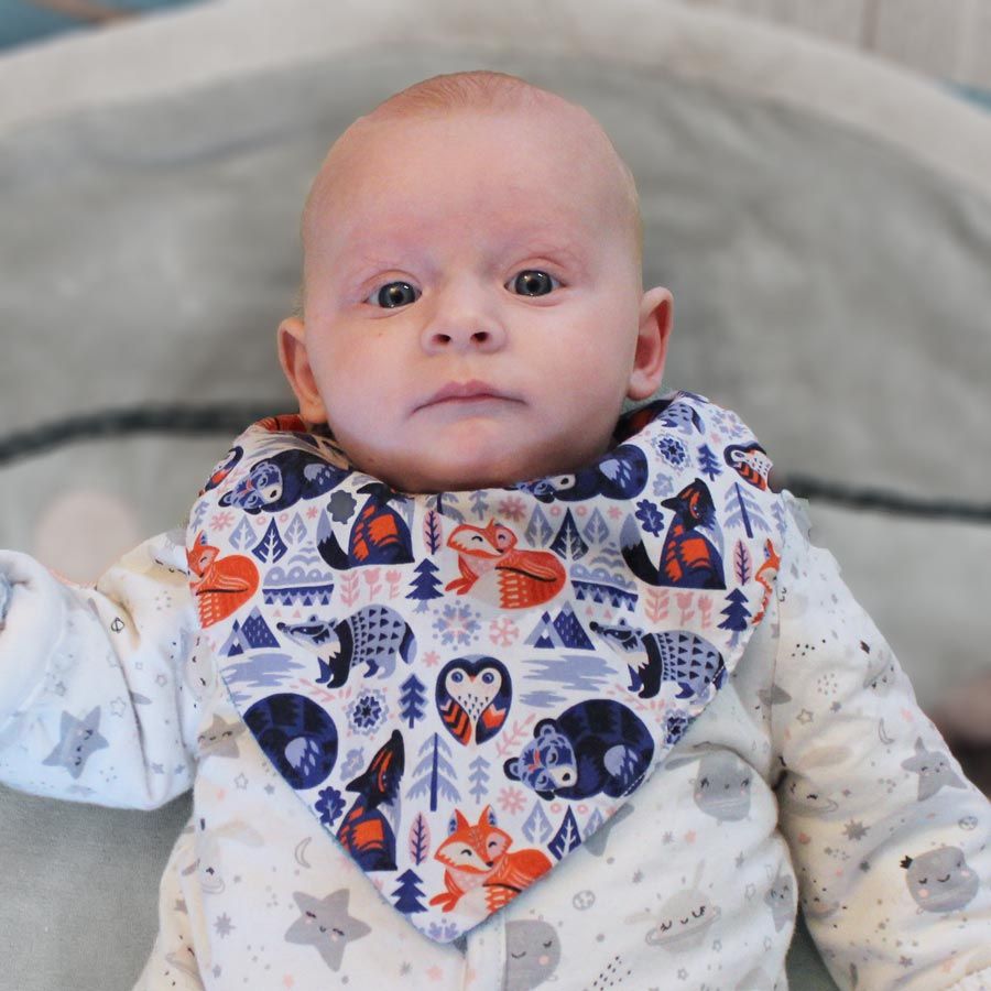 Baby wearing a bib made of Organic cotton poplin 