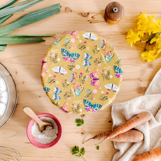 Table composition with a bol and a cover ball made of Colourful Organic cotton poplin with buterflies and flowers on it